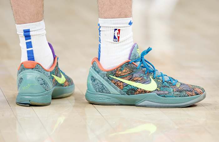 View of green and yellow Nike Kobe shoes.